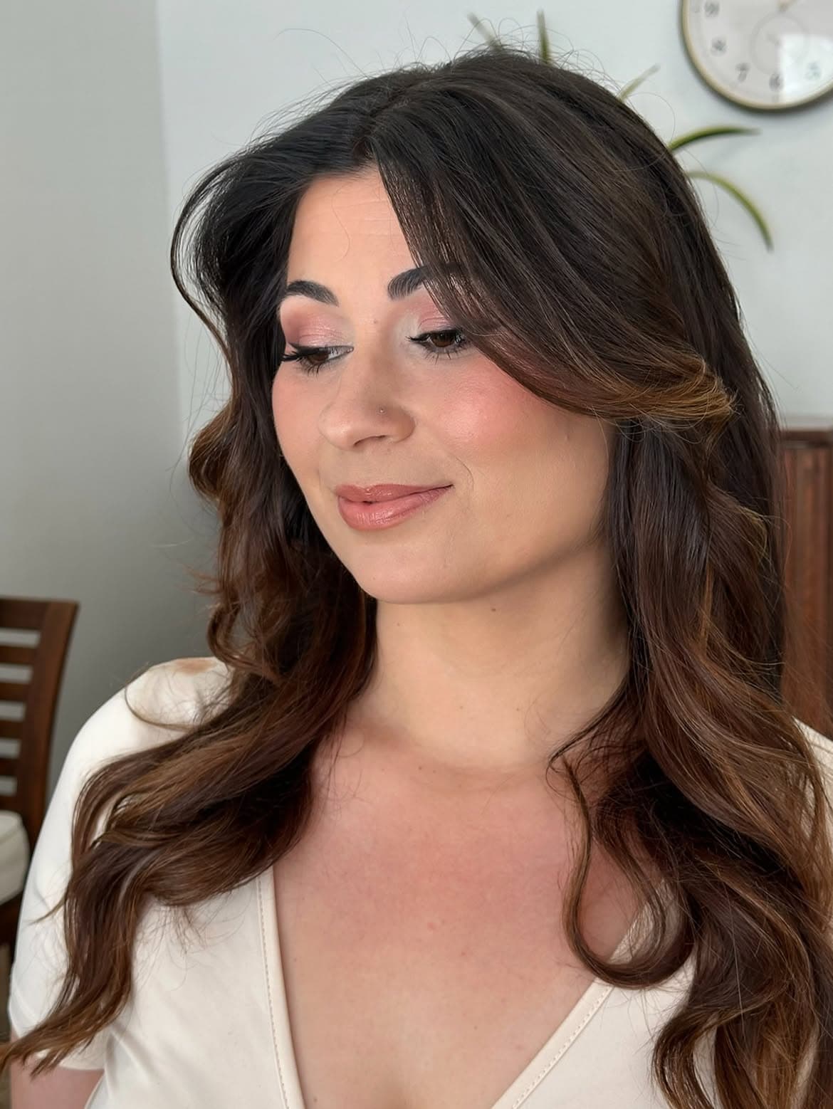 Maquilhagem natural em tons rosados, com o cabelo ondulado solto